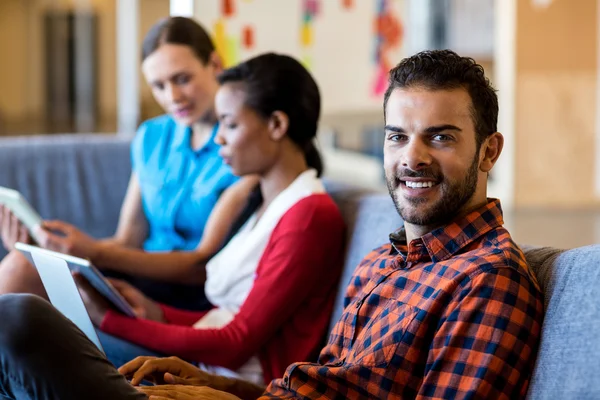 Colleagues using tablet and laptop — Stock Photo, Image