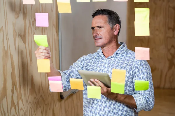 Hombre reflexivo sosteniendo la tableta — Foto de Stock