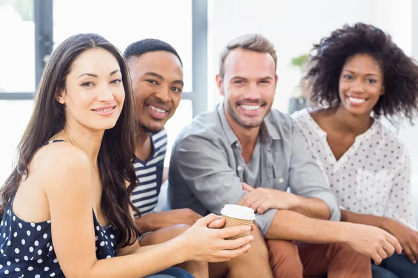 Friends sitting together on sofa — Stock Photo, Image