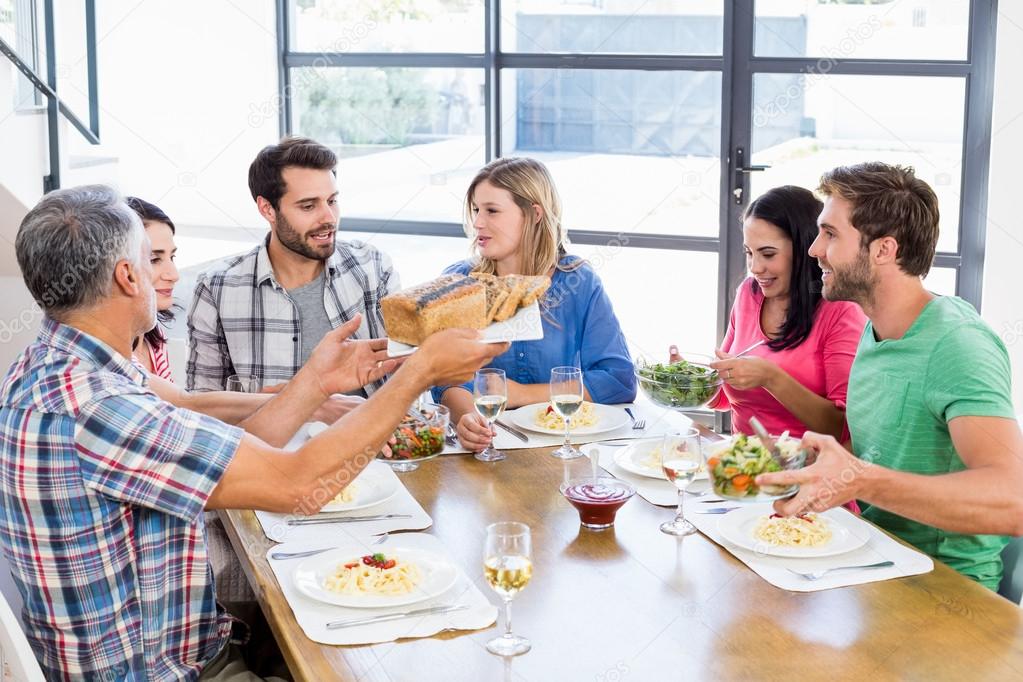 Friends interacting while having meal — Stock Photo © Wavebreakmedia  #106157050