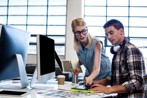 Graphic designer interacting at their desk — Stock Photo, Image