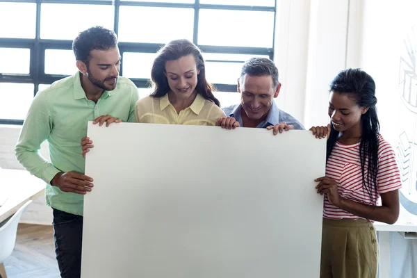 Colleagues holding blank board — Stock Photo, Image