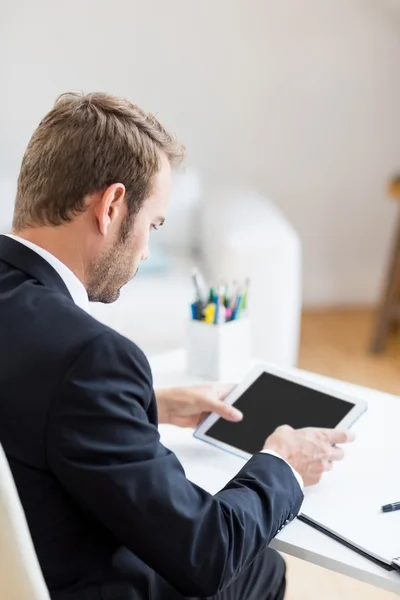 Businessman using tablet at desk — Stock Photo, Image
