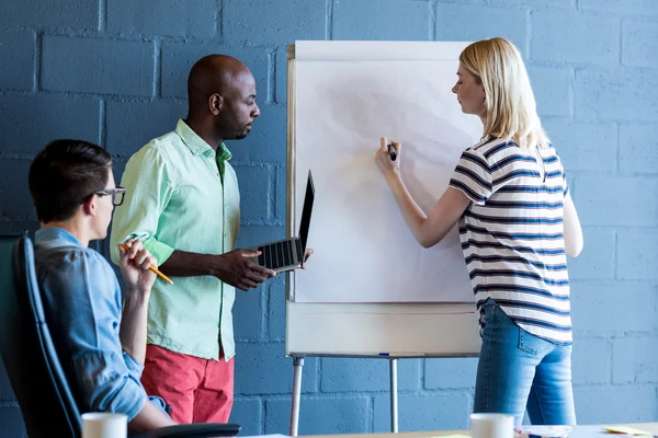 Team looking while colleague writing — Stock Photo, Image