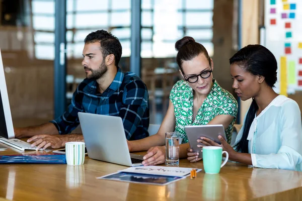 Man and women sitting at their desk — Stock Photo, Image