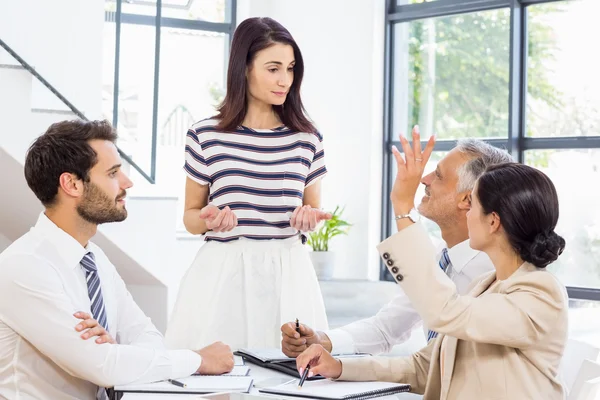 Woman looking at her colleagues — Stock Photo, Image