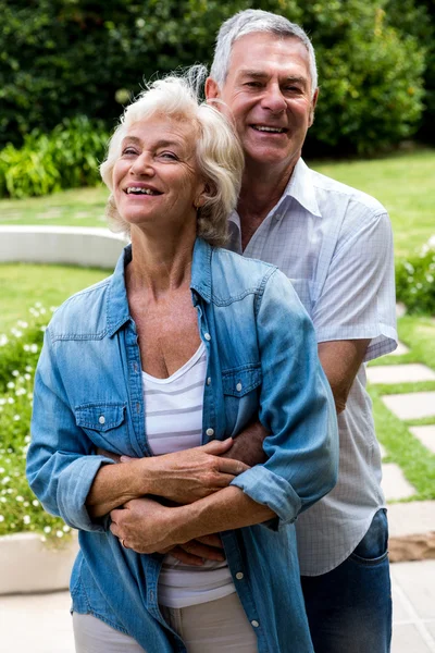 Senior man embracing from behind — Stock Photo, Image