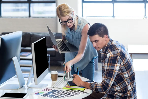 Graphic designer interacting at their desk — Stock Photo, Image