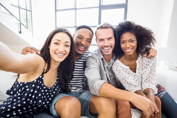 Friends sitting together on sofa — Stock Photo, Image