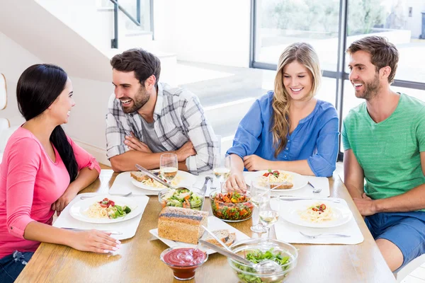 Friends interacting while having meal — Stock Photo, Image