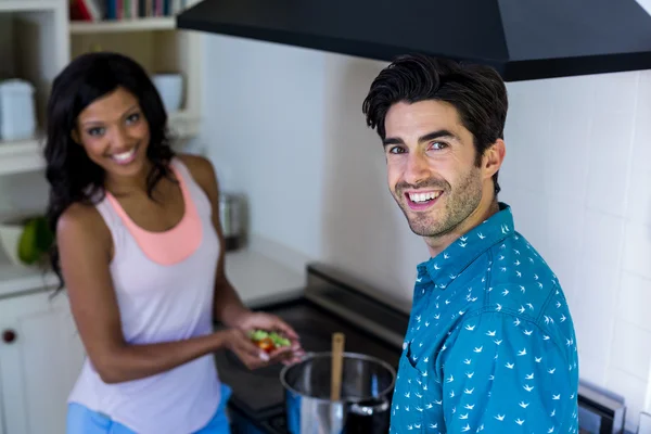 Couple cooking food in kitchen — Stock Photo, Image