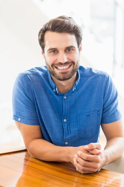 Man is sitting at table — Stock Photo, Image