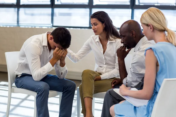 Colleagues comforting a unhappy man — Stock Photo, Image