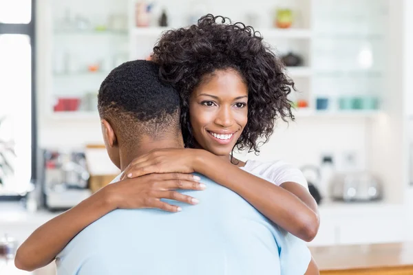 Young couple embracing in kitchen — Stock Photo, Image