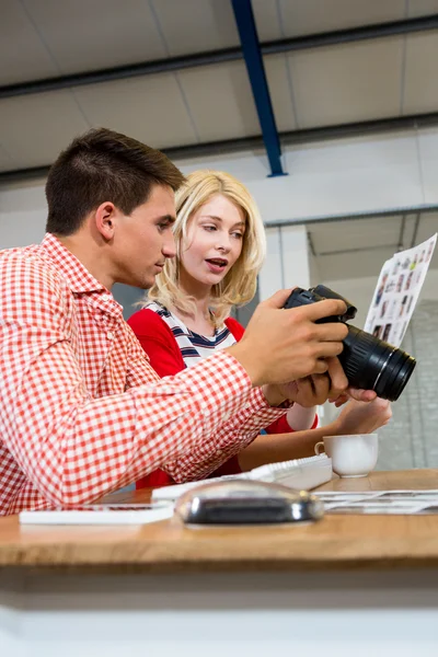 Colleagues checking a photos in camera — Stock Photo, Image
