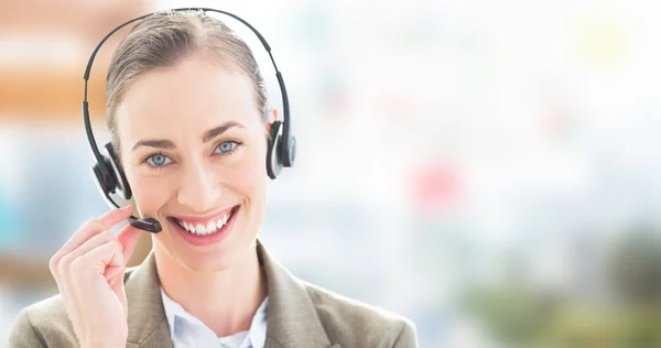 Businesswoman with headset looking at camera — Stock Photo, Image