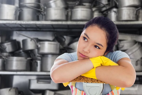 Troubled woman leaning on a mop — Stock Photo, Image