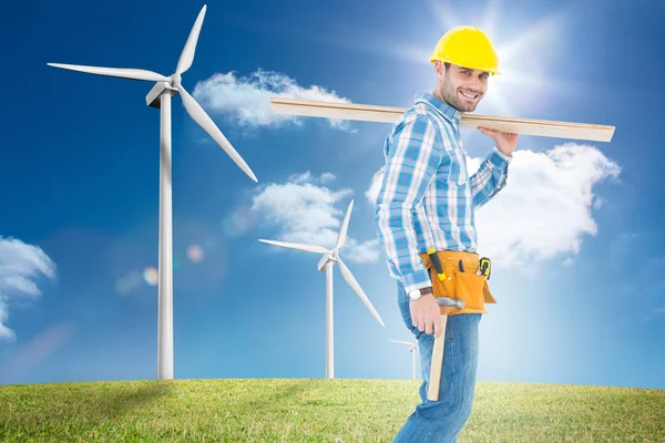 Worker carrying wooden planks — Stock Photo, Image