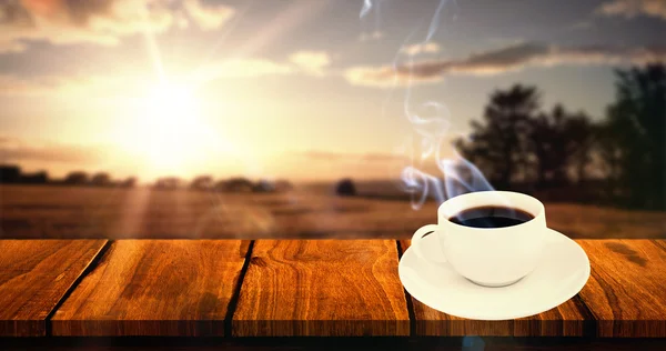 Xícara de café contra paisagem — Fotografia de Stock