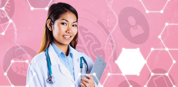 Asian doctor holding clipboard — Stock Photo, Image