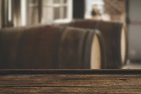 Wooden flooring against large barrels — Stock Photo, Image