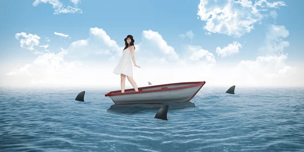 Woman twirling in dress against sharks — Stock Photo, Image