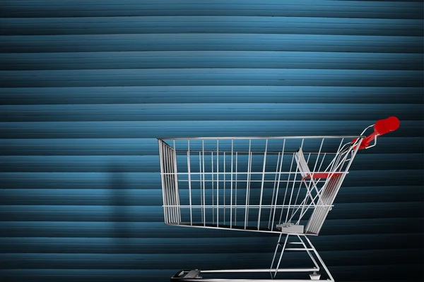 Shopping cart against grey shutters — Stock Photo, Image