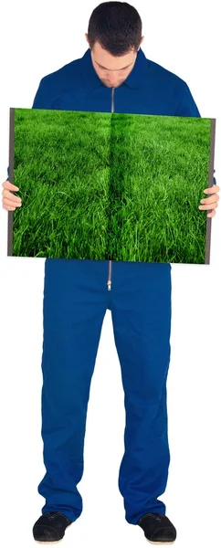 Человек держит газон книгу — стоковое фото