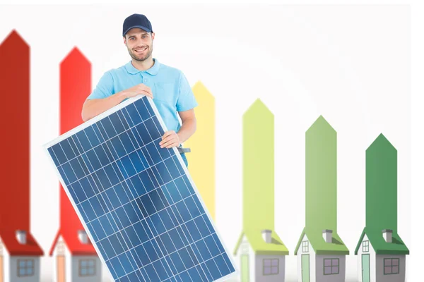 Construction worker holding solar panel — Stock Photo, Image