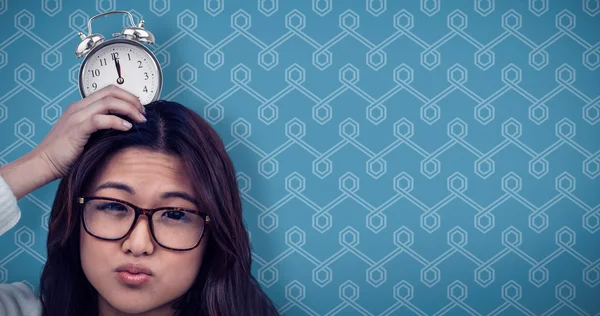 Woman with alarm clock on head — Stock Photo, Image