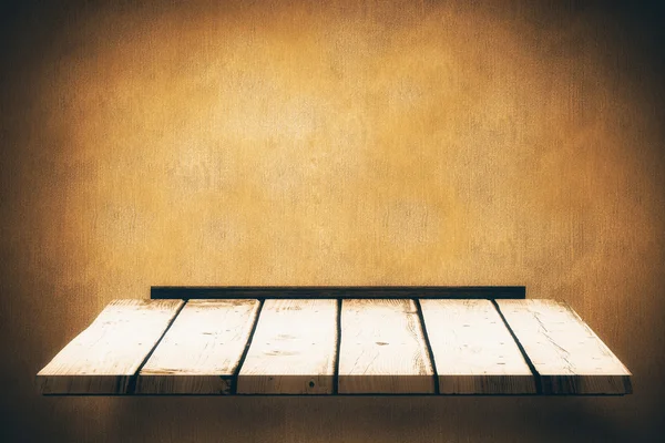 Wooden shelf against texture wall — Stock Photo, Image