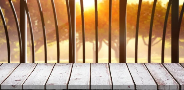 Wooden table against structure on forest — Stock Photo, Image