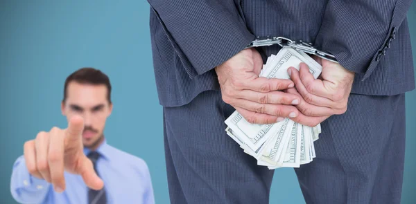 Businessman with handcuffs and money — Stock Photo, Image