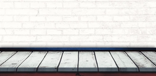 Wooden table against white wall — Stock Photo, Image