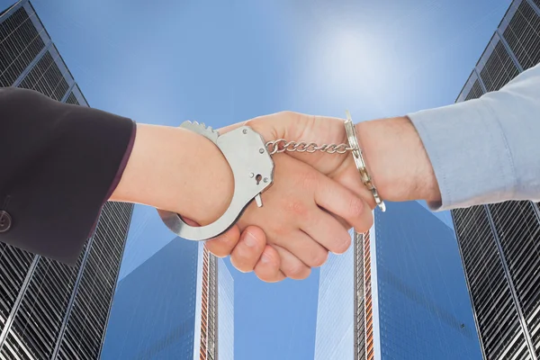 Business people in handcuffs shaking hands — Stock Photo, Image