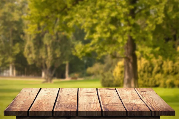 Wooden floor against trees and meadow — Stock Photo, Image