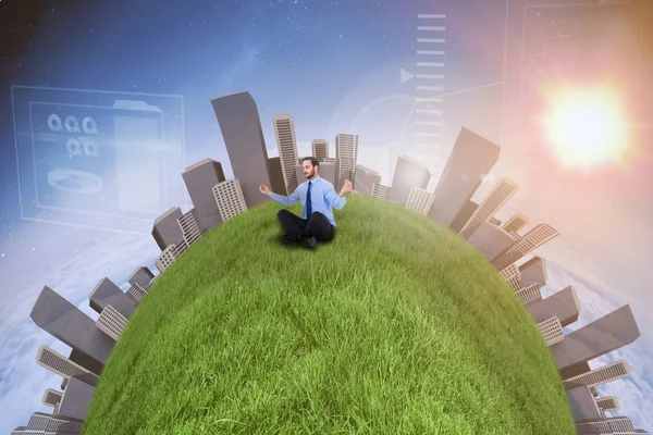 Businessman in suit sitting in lotus pose — Stock Photo, Image