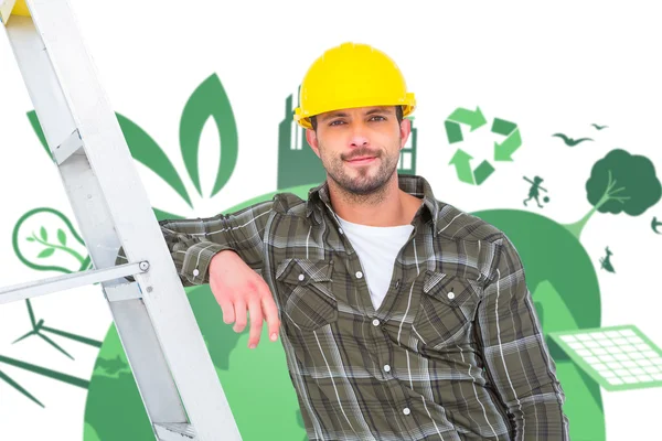 Handyman in overalls leaning on ladder — Stock Photo, Image