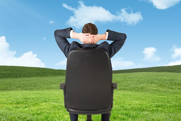 Businessman sitting in swivel chair — Stock Photo, Image