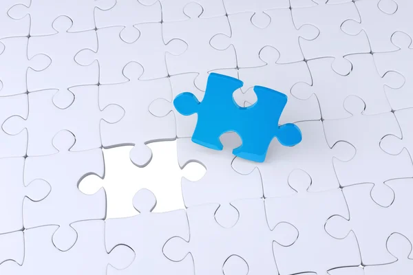 Jigsaw pieces on white texture — Stock Photo, Image