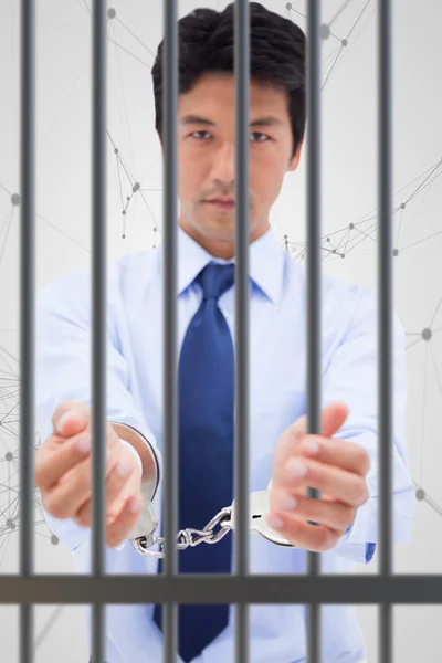 Businessman with handcuffs against black lines — Stock Photo, Image