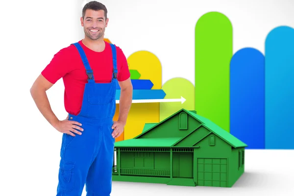 Handyman in overalls with hands on hip — Stock Photo, Image