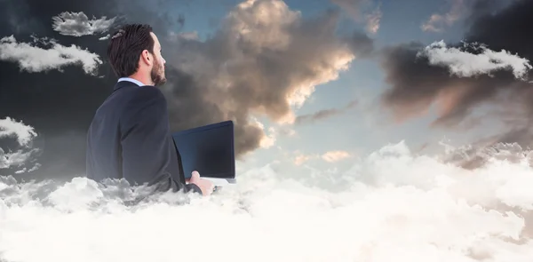 Businessman in suit holding laptop — Stock Photo, Image