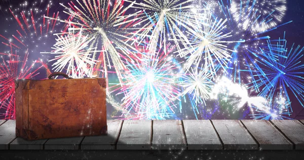 Suitcase against fireworks exploding — Stock Photo, Image