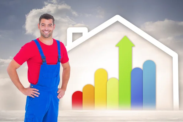 Handyman in overalls with hands on hip — Stock Photo, Image