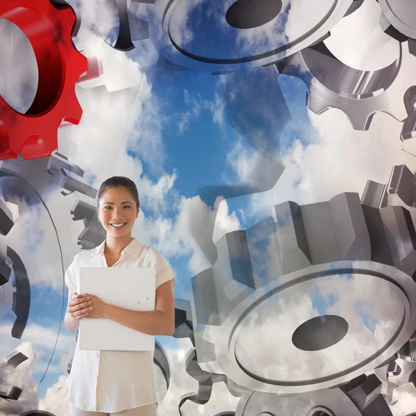 Businesswoman smiling at camera holding folder — Stock Photo, Image