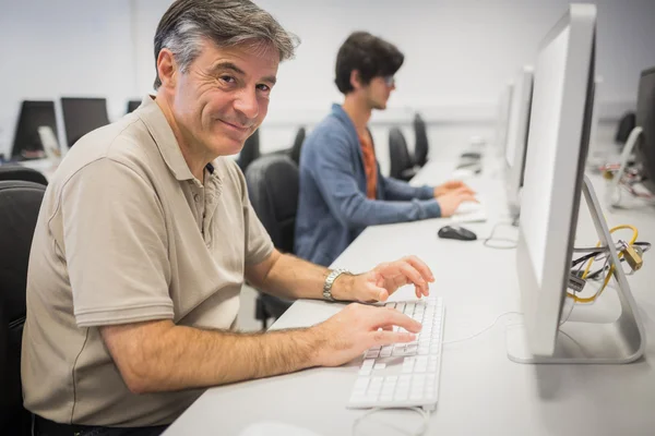 Portrait of happy professor working on computer — Stock Photo, Image