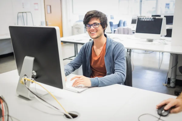 Portrait of happy student using computer — Stock Photo, Image