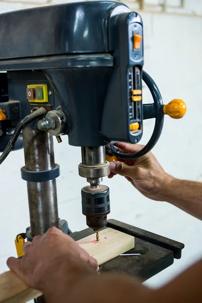 Carpenter using a drill — Stock Photo, Image