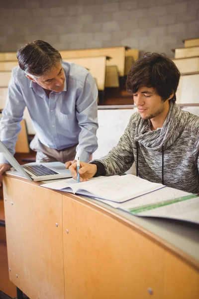 Professor helping a student in classroom — Stock Photo, Image